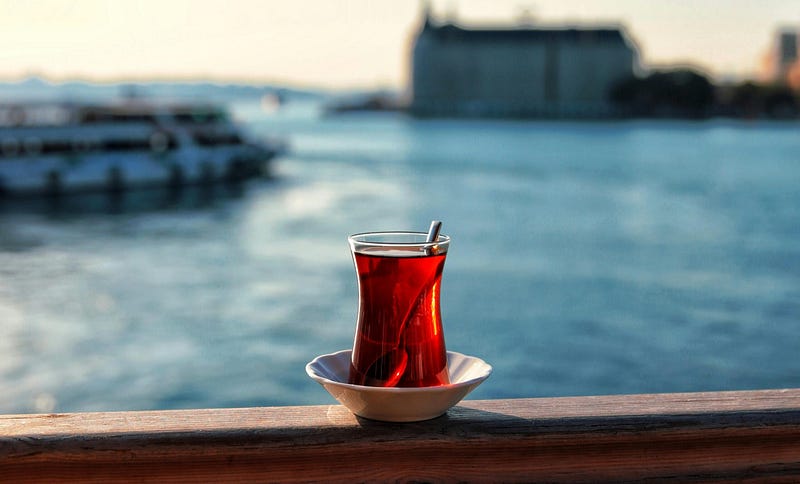 A glass of Turkish tea on a saucer.